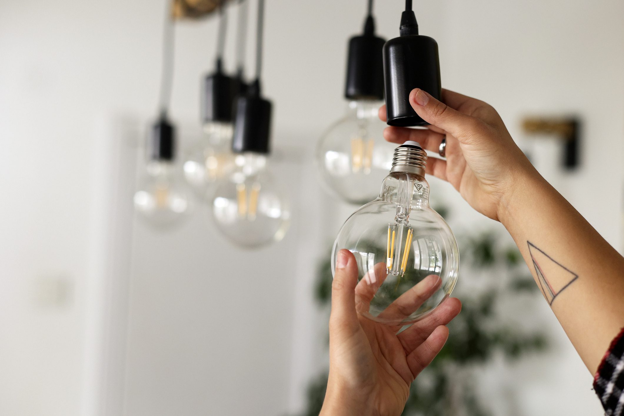 Woman installing energy efficient light bulbs
